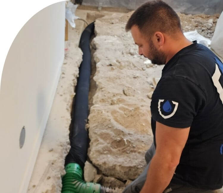 technician installing weeping tile for waterproofing rebate