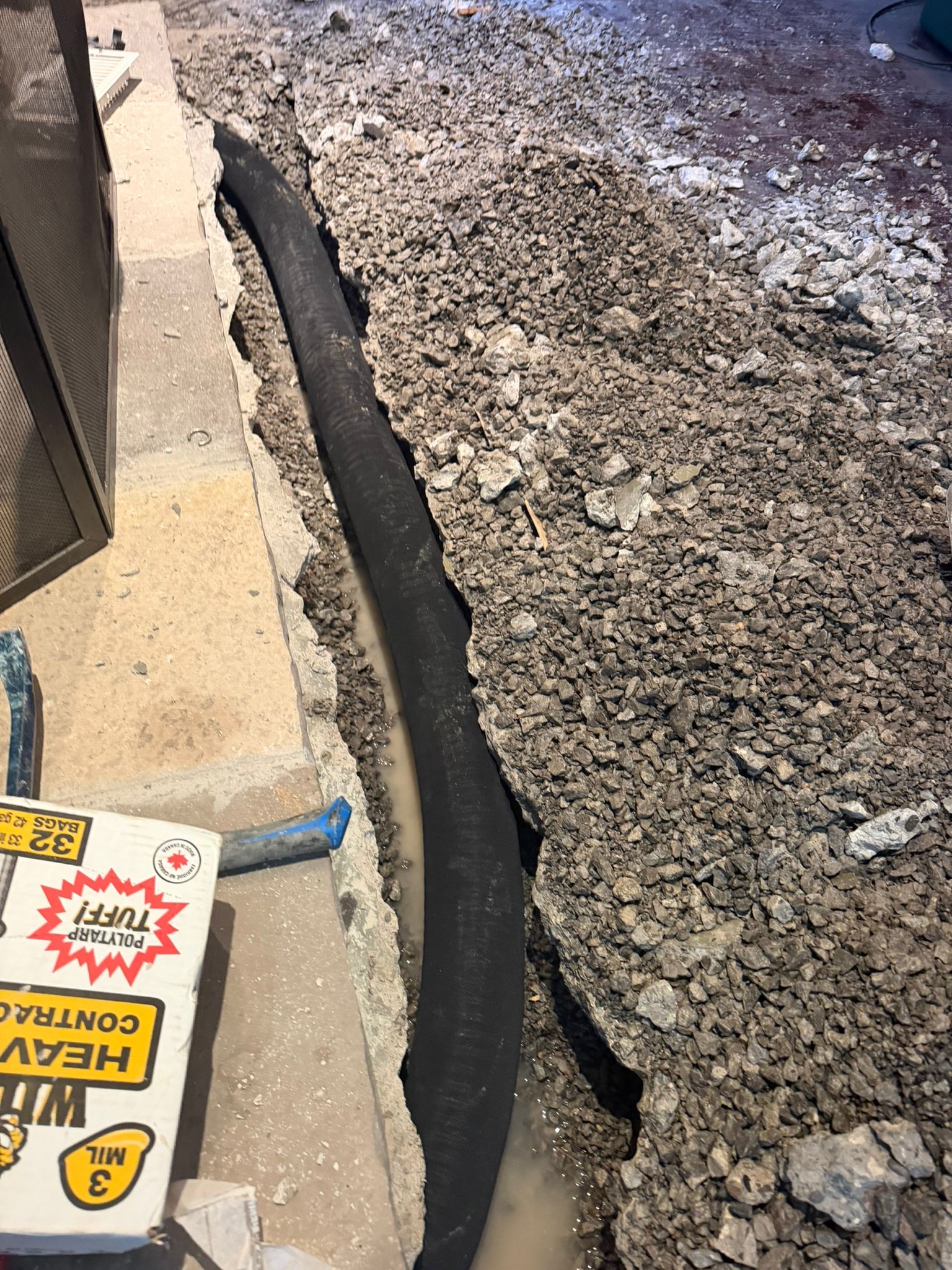 Open basement floor trench with weeping tile designed to relieve hydrostatic water pressure in Pickering.