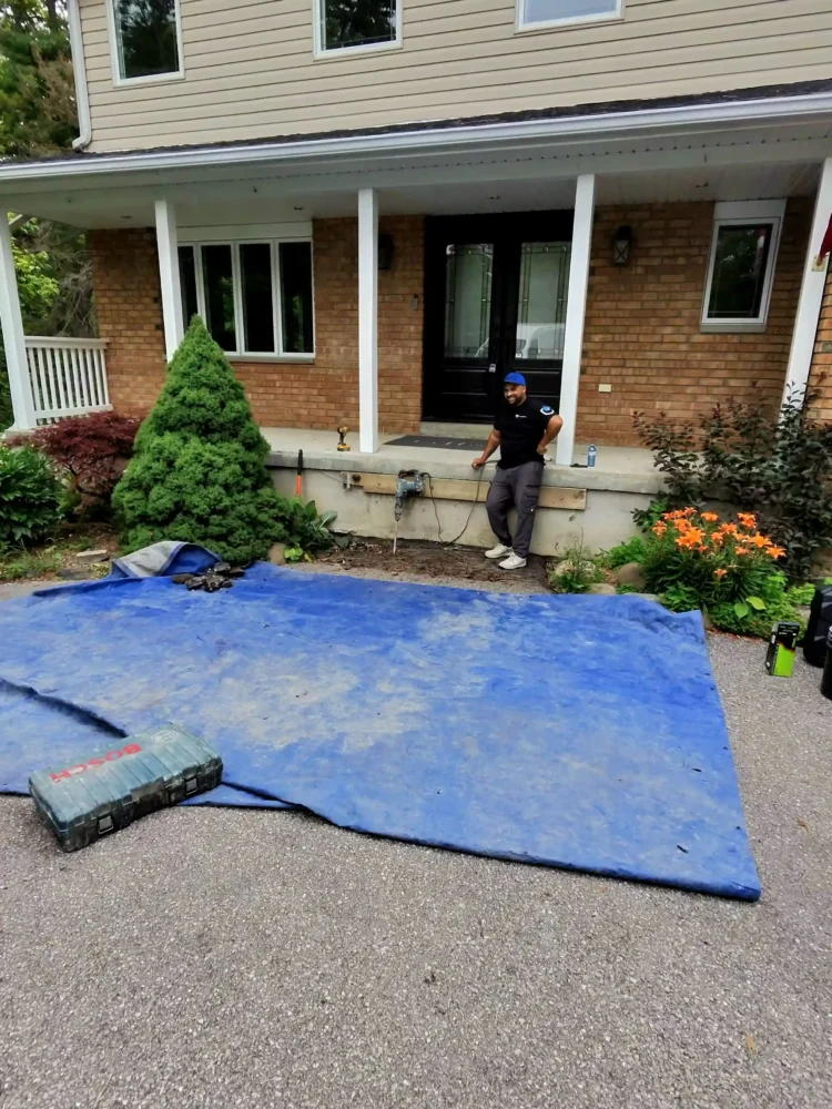 DGI Waterproofing contractor preparing the site with protective tarps before exterior waterproofing excavation in Innisfil.