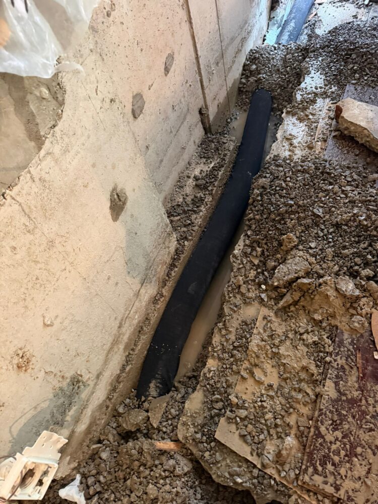 Interior weeping tile and gravel installation along a basement foundation wall in Pickering.