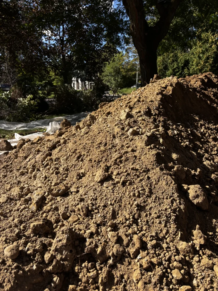 Excavated dirt securely contained during a residential exterior foundation waterproofing and crack repair project in Toronto.